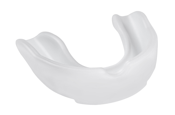 Opaque white plastic mouthguard on a white background